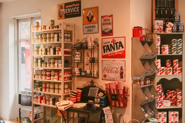 Vintage shop interior with Fanta and Coca-Cola signs, shelves of jars and canned goods in Akureyri