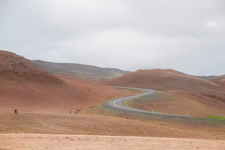 Winding road through red volcanic hills on a custom Akureyri day trip from cruise port