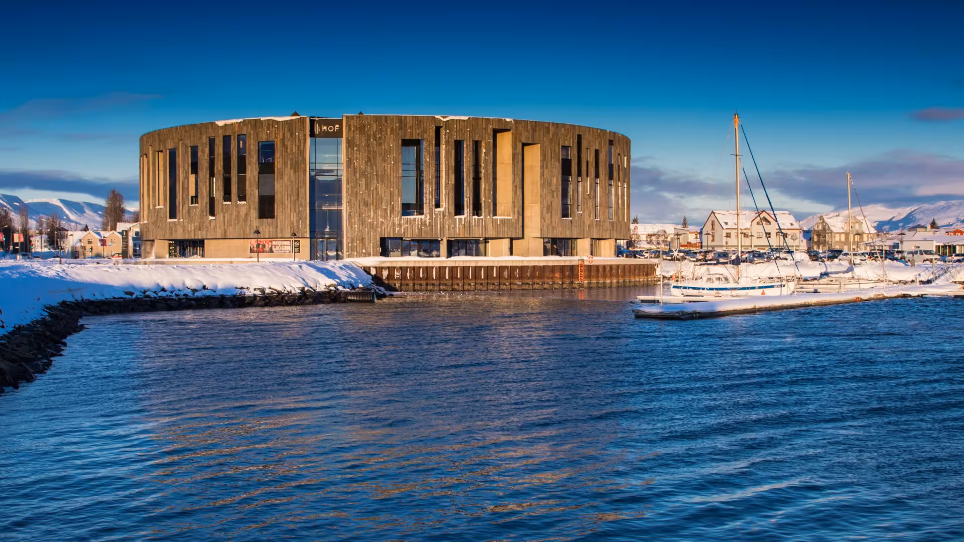 HOF cultural center building on Akureyri harbor waterfront in winter with snow-covered surroundings