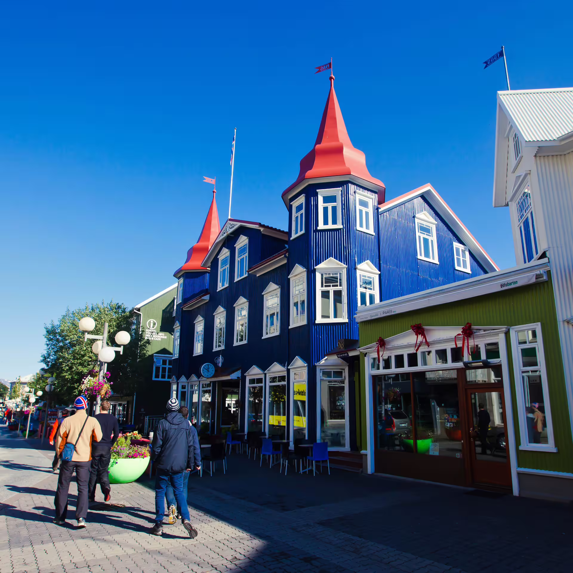 Colorful blue buildings with red turrets on Akureyri pedestrian street on a sunny day
