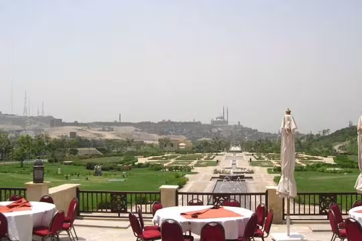 Outdoor dinner terrace at Al Azhar Park with garden views over Cairo, included in Al-Mu'izz Street evening tour