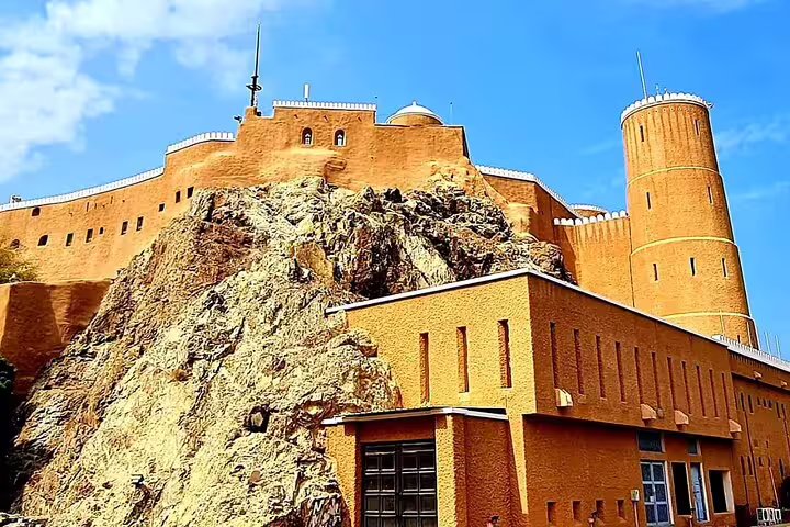 Explore the historic Al Jalali Fort perched on rocky cliffs, a highlight of the Private Half Day Muscat City Tour Afternoon.