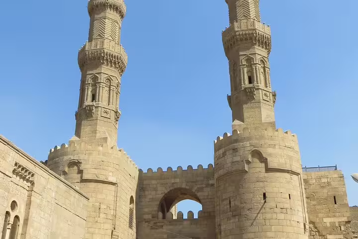 Historic stone towers and arch on Al Moez Street, Islamic Cairo, featured on Cairo by Night tour near Al Fishawi café