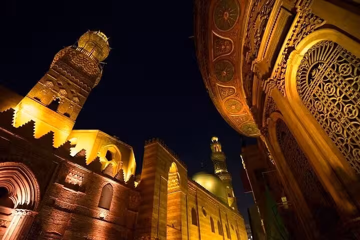 Night view of Al Muizz Street Cairo, glowing minarets and Islamic architecture on VIP guided tour