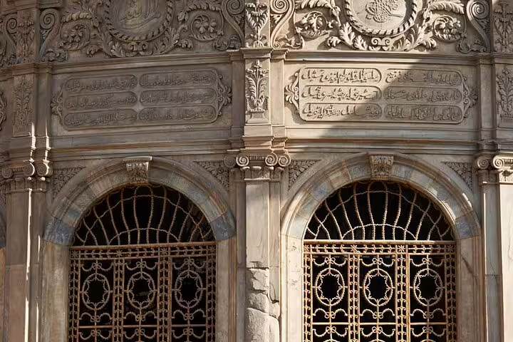 Ornate Islamic stone carvings and arched windows on Al-Mu'izz Street in Cairo on a guided evening tour