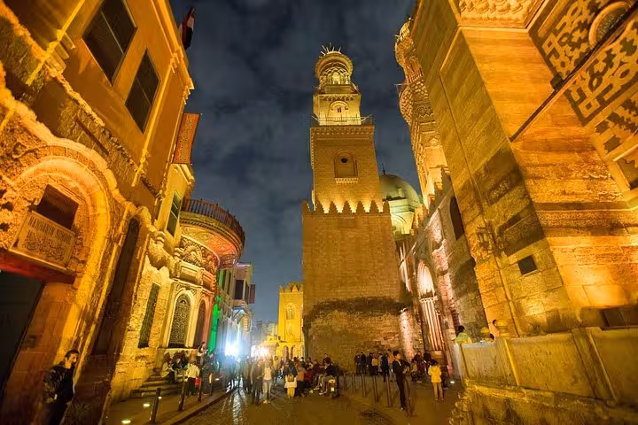 Night view of Al-Muizz Street minaret and Old Cairo crowds, part of Coptic Cairo and bazaar day tour