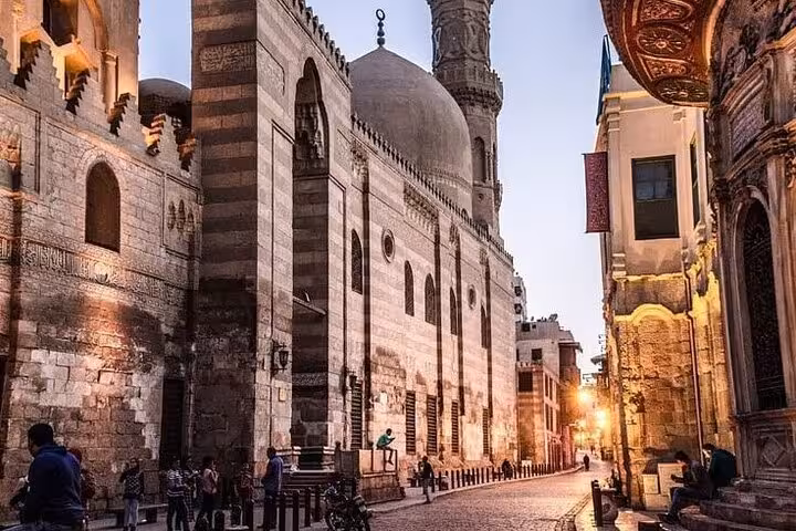 Al-Muizz Street mosque facade at sunset, Historic Islamic Cairo walking tour with Egyptian street food