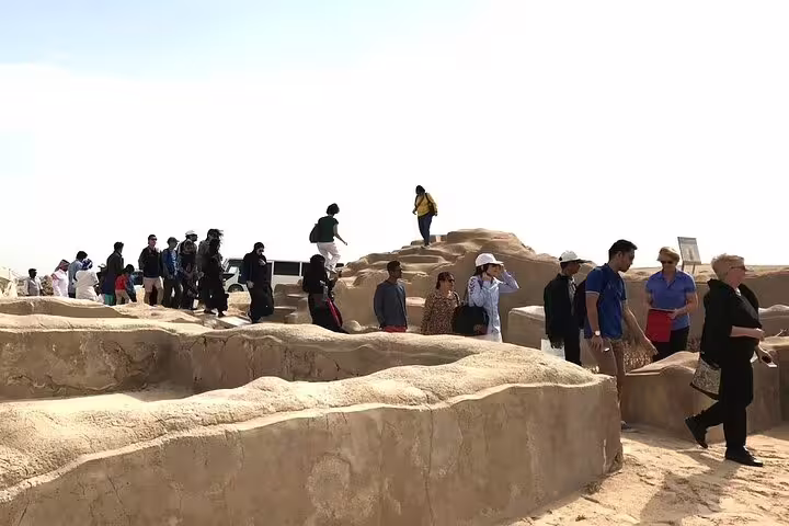 Tourists exploring the archaeological ruins of Al Zubarah, highlighting Qatar's rich cultural heritage.