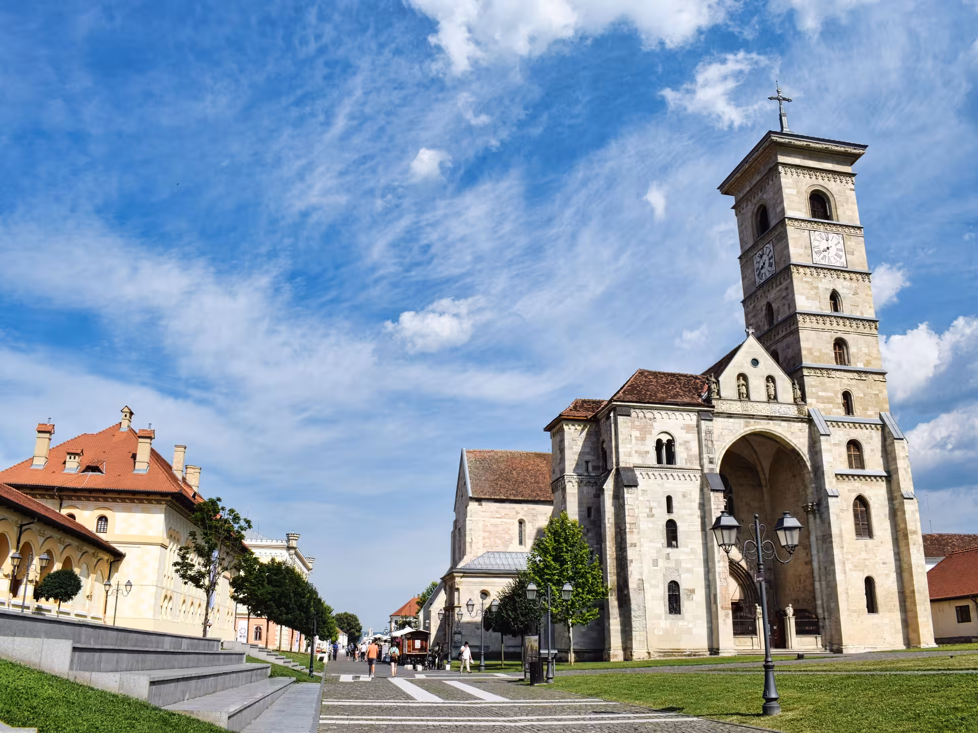 Historic Alba Iulia Cathedral with clock tower on a sunny day during a full-day tour of Transylvania Romania