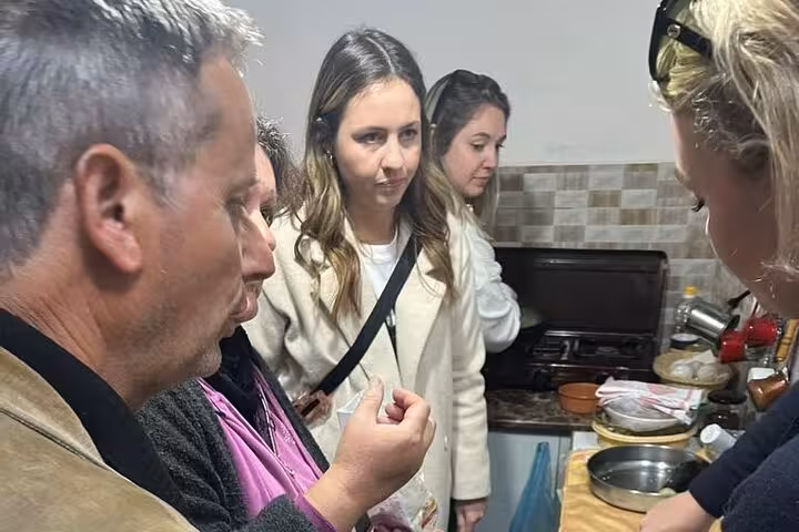 Group tasting authentic Albanian cuisine at a cooking class in Berat, showcasing local culinary traditions.