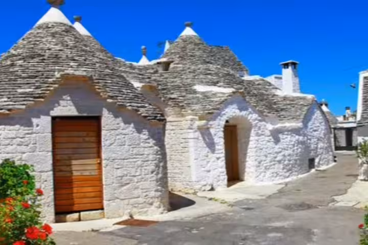 Traditional white trulli houses with conical roofs in Alberobello, Puglia, visited on a 6-day self-drive tasting itinerary