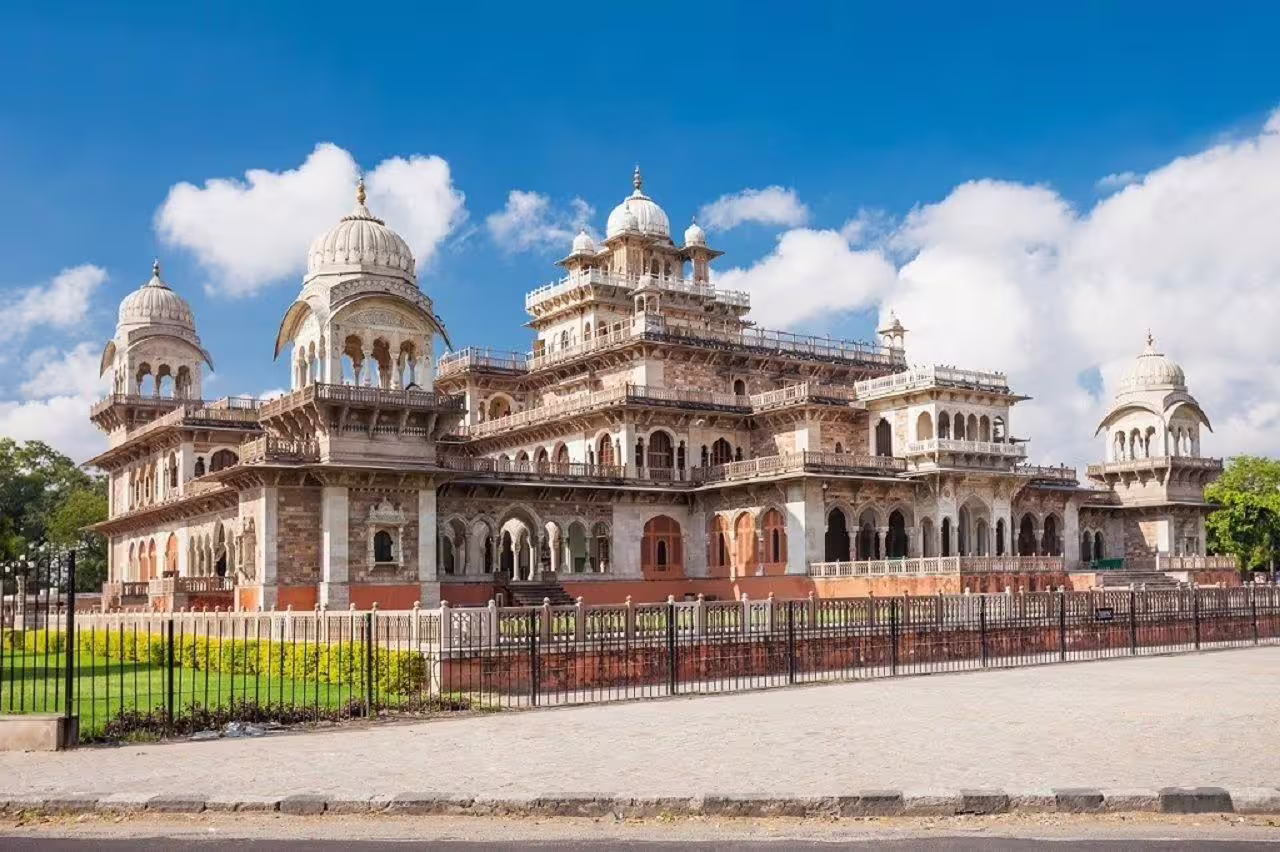 Majestic view of Albert Hall Museum's intricate architecture under a vibrant blue sky in Jaipur, India.