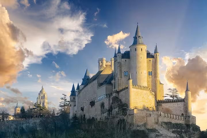 Majestic view of the Alcázar of Segovia against a dramatic sky on a day tour from Madrid.