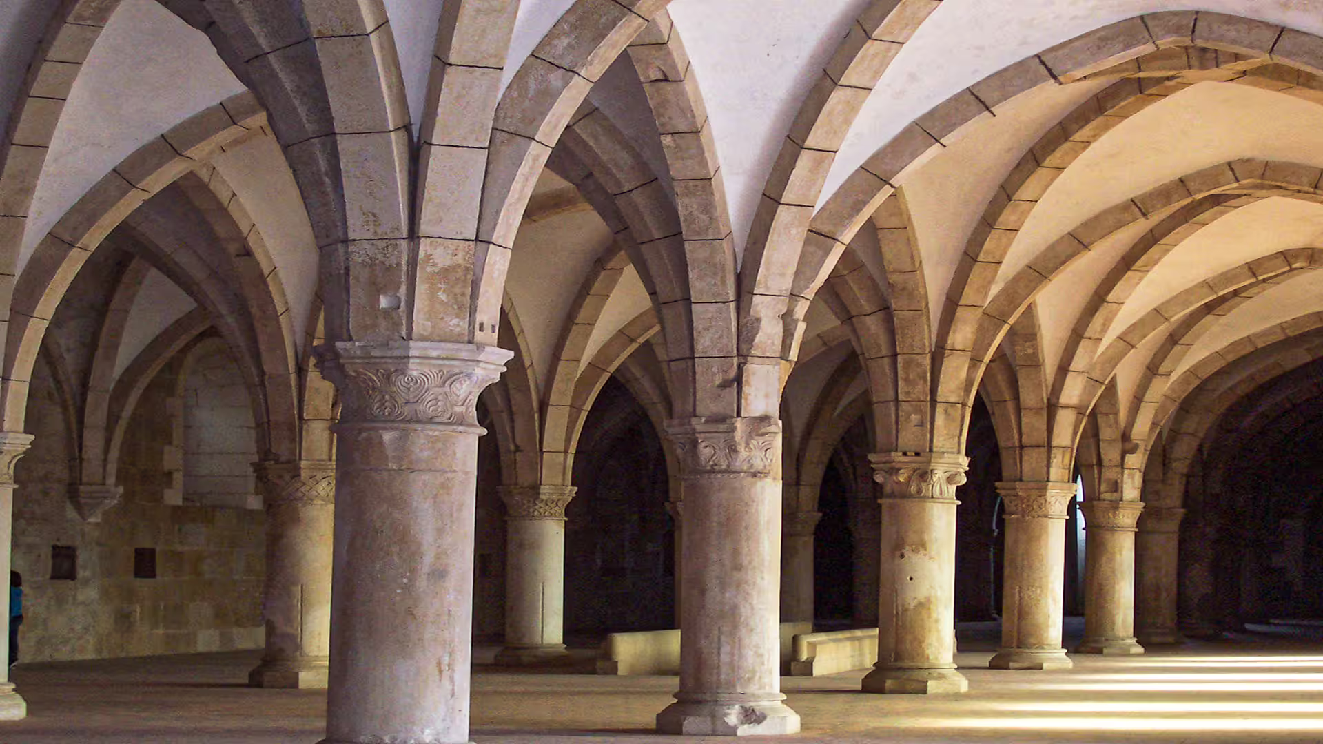 Historic arches inside Alcobaça Monastery, showcasing stunning architecture on a private tour to Nazaré and Alcobaça.