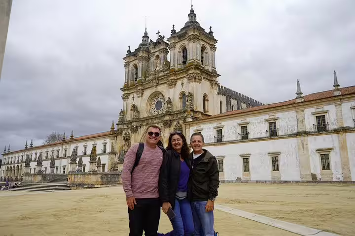 Tourists enjoying a visit to the historic Alcobaça Monastery, part of the Óbidos, Nazaré, and Fatima tour from Vicentine Coast.