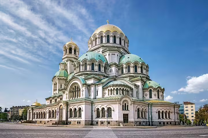 Alexander Nevsky Cathedral in Sofia, a grand Orthodox church with green and gold domes under blue sky