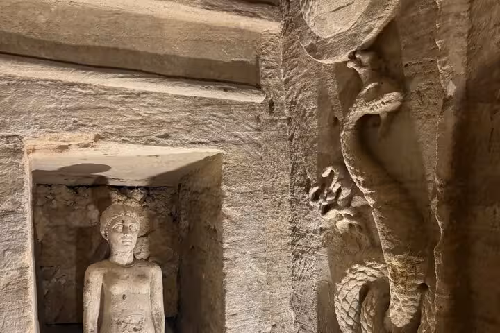 Ancient carved niche statue and stone relief at Alexandria Catacombs on VIP private day tour with expert guide