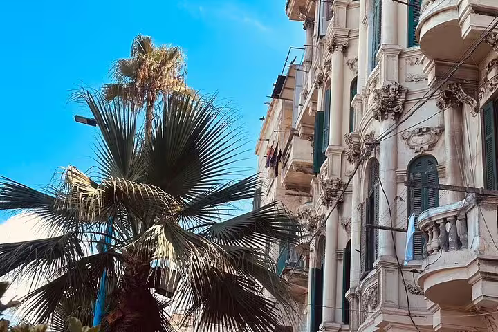 Alexandria Egypt historic street with palm trees and ornate balconies, ideal stop on 6-day Egypt tour package