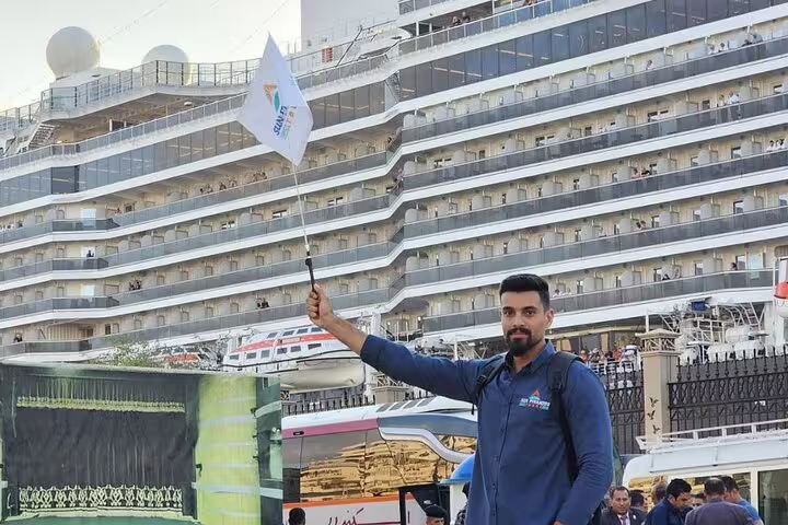 Tour guide greeting cruise guests at Alexandria Port for private day trip to Giza Pyramids and Sakkara