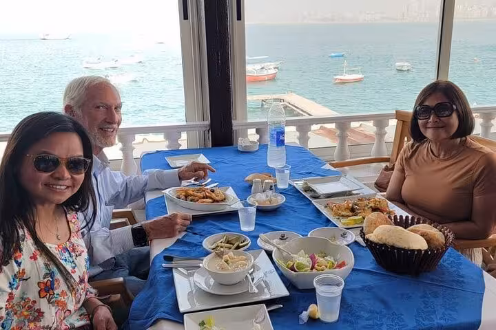 Sea-view lunch stop in Alexandria on a private guided day tour from Cairo, with fresh seafood and marina boats