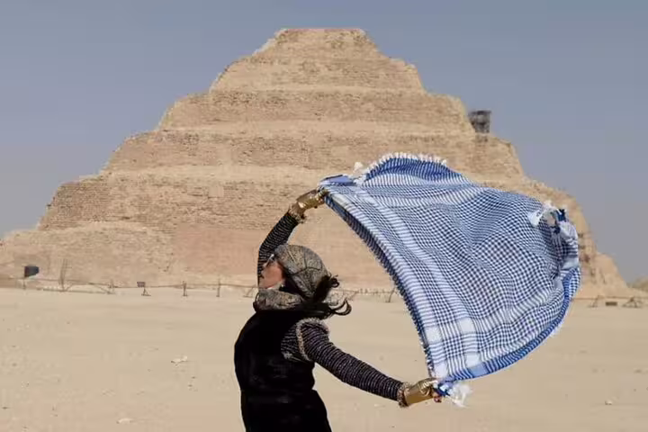 Visitor at Sakkara Step Pyramid on Alexandria port private tour, desert photo stop before camel ride