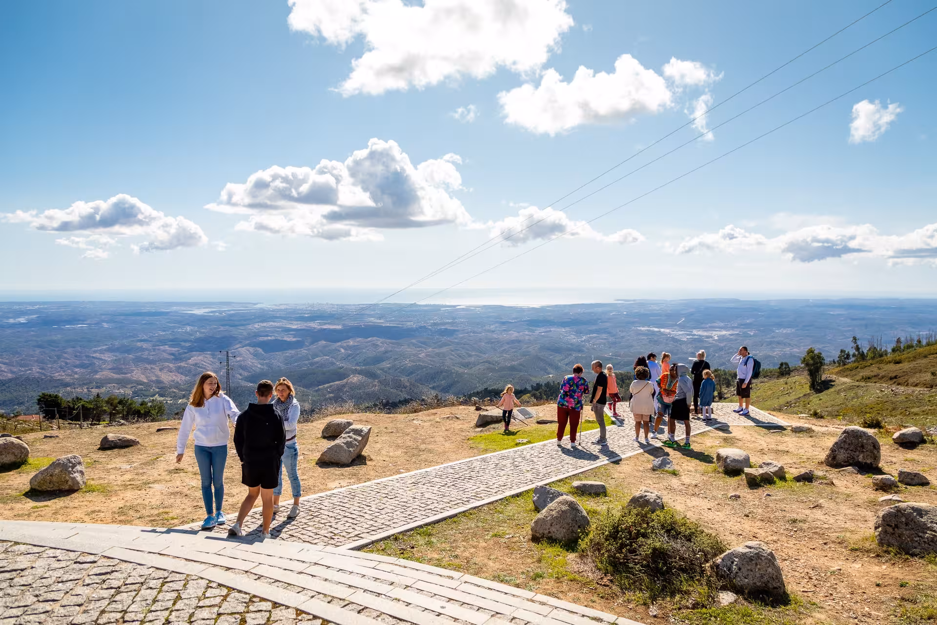 Tourists enjoying panoramic mountain viewpoint over Algarve coastline and rolling hills on Algarve à la Carte sightseeing tour