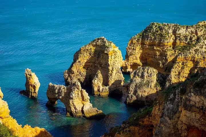 Scenic Algarve coastline with stunning rock formations and turquoise waters on a private 2-day tour from Lisbon to Algarve.