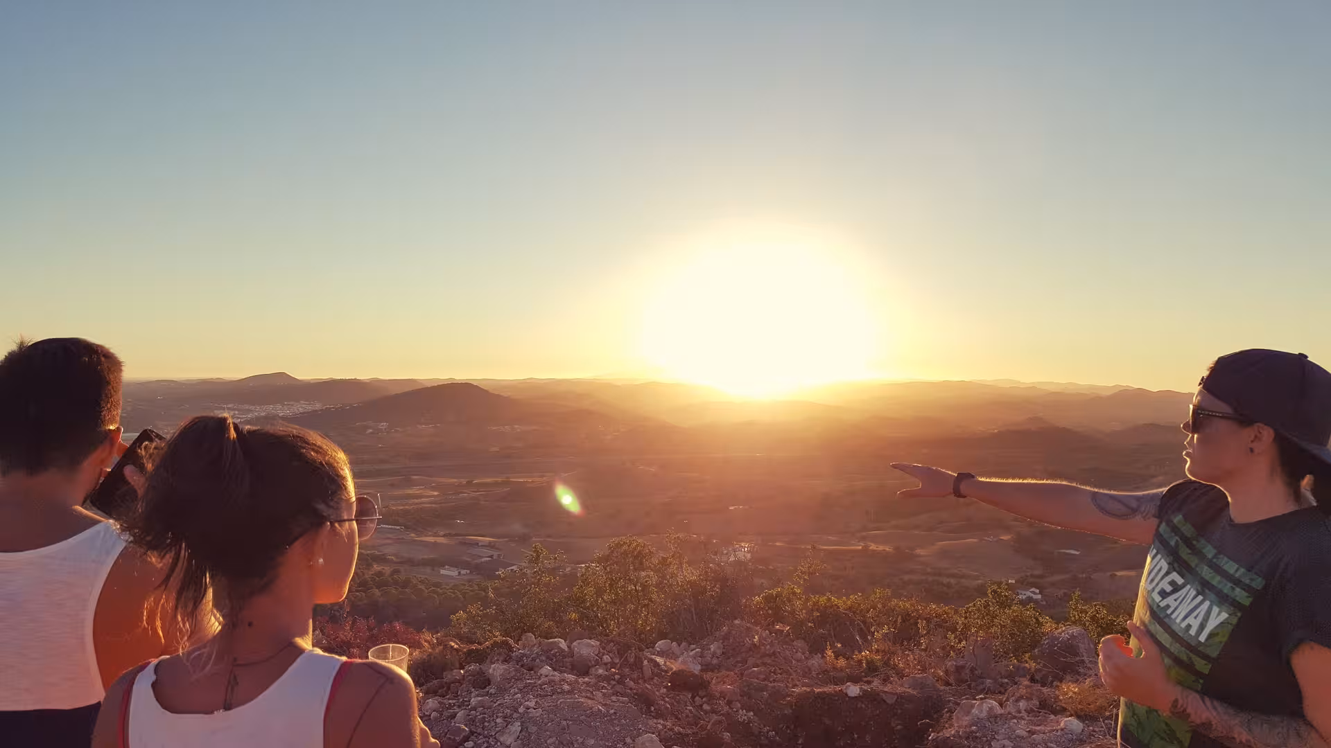 Travellers on Algarve jeep safari watching golden sunset over Serra de Monchique hills before dinner experience