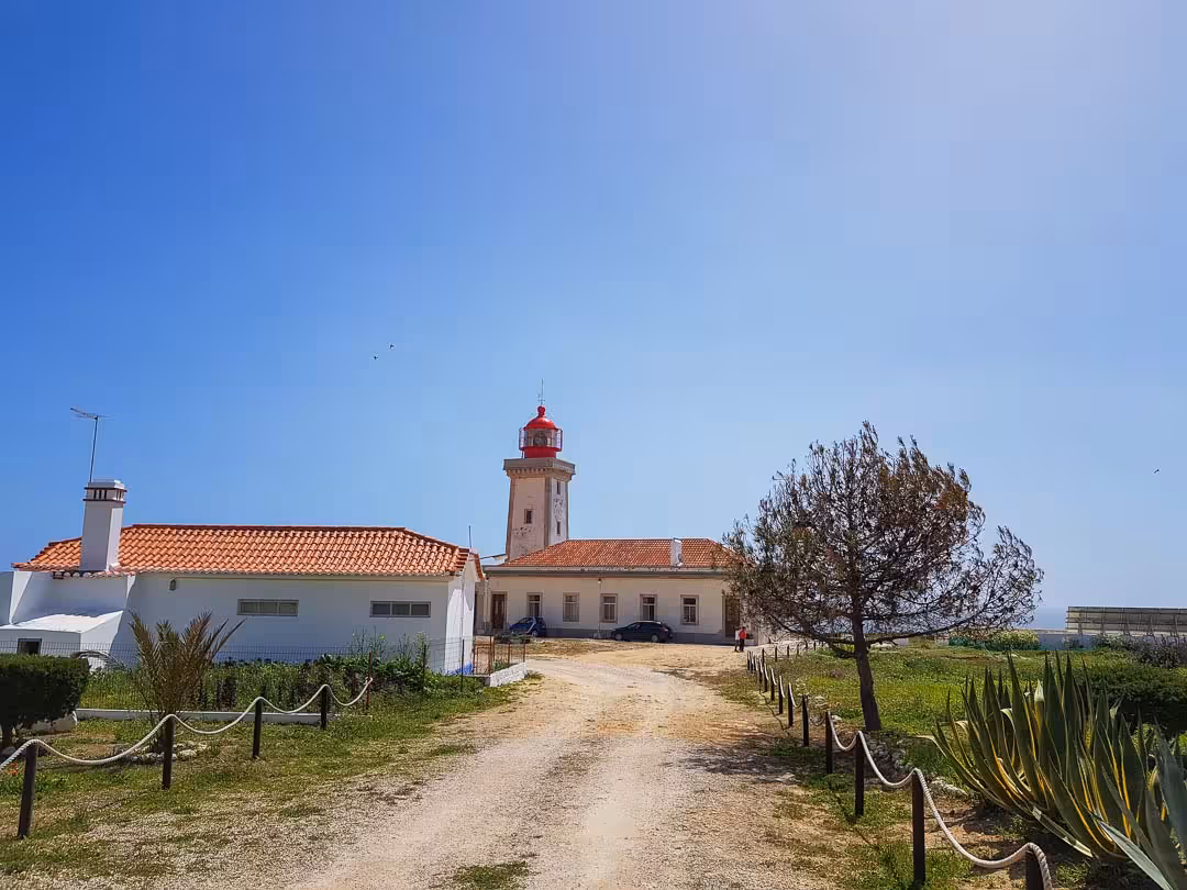 Scenic Algarve lighthouse with terracotta roof and gravel path on the Seven Hanging Valleys guided tour