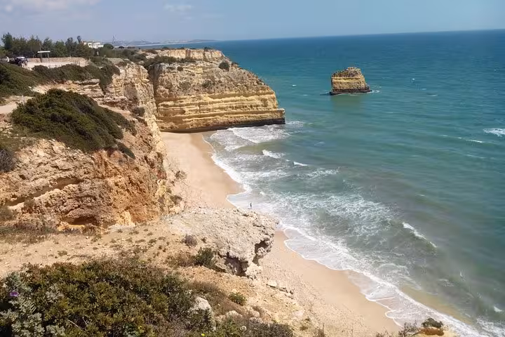 Scenic Marinha Beach with golden cliffs and azure waves, perfect for exploring on an Algarve private tour.