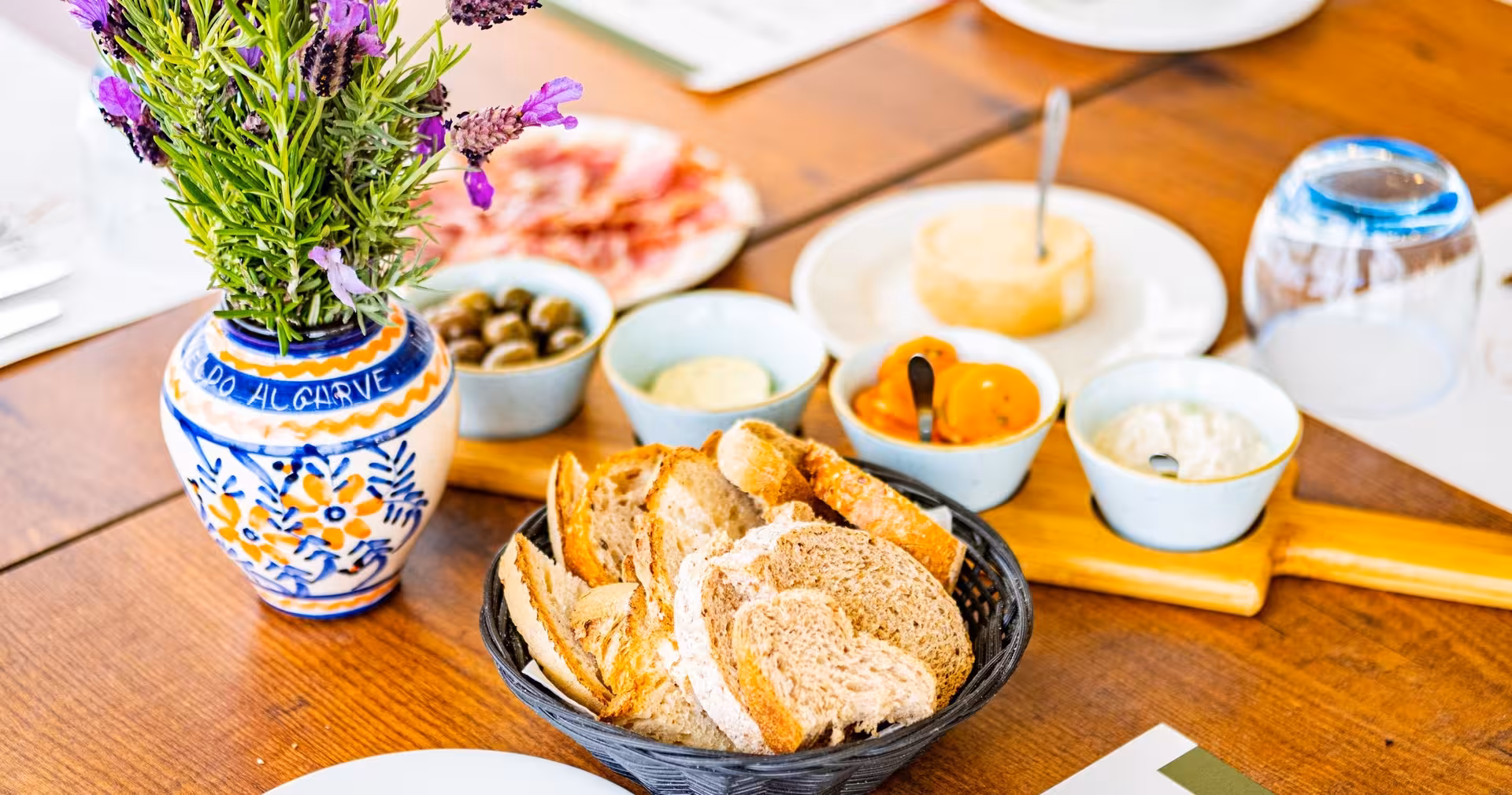 Rustic Algarve appetizer spread with fresh bread, olives and dips served during countryside full day quad tour stop