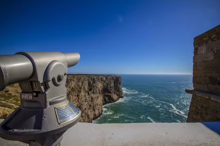 Telescope view of stunning Algarve cliff and ocean on West Coast secret spot tour.