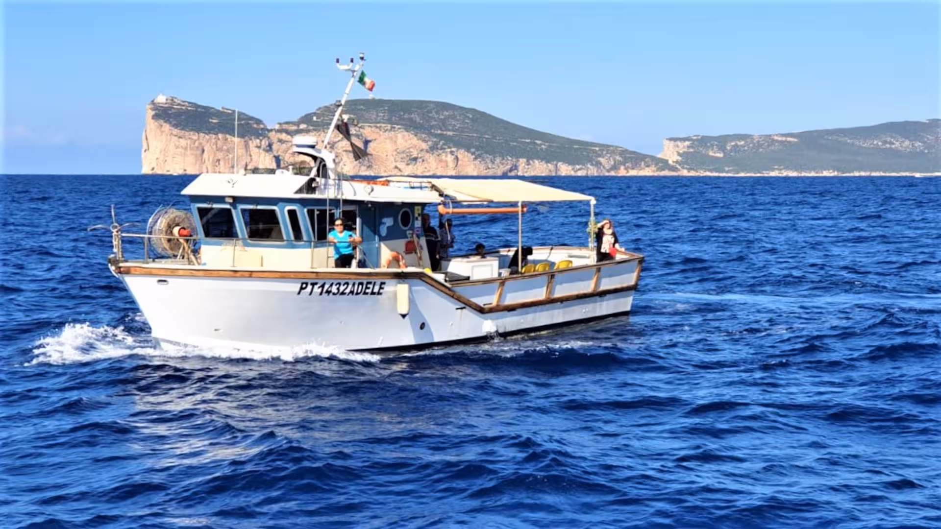 Explore the stunning Capo Caccia coastline on a guided fishing tour aboard a boat in Alghero's clear blue waters.