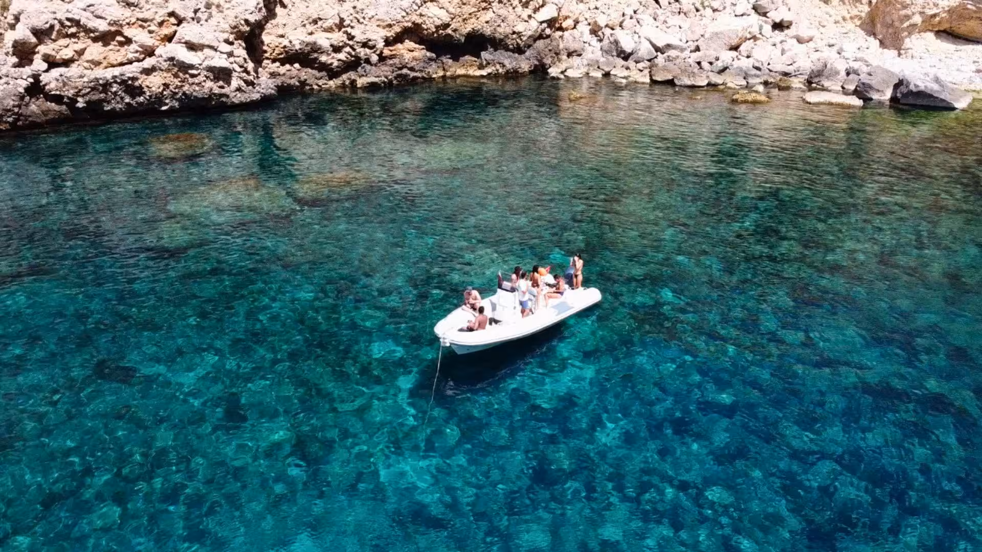Enjoy a scenic dinghy tour on the azure waters near Capo Caccia, perfect for a relaxing Alghero adventure.