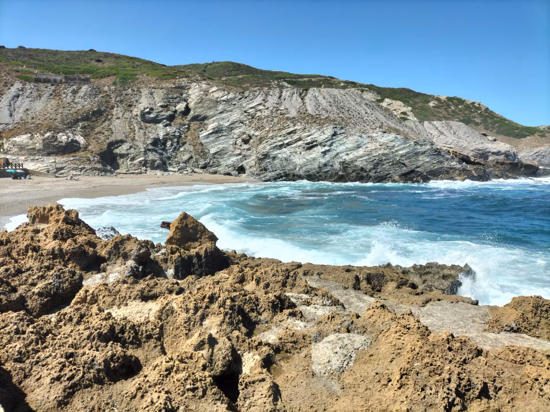Rugged coastline of Porto Ferro with crashing waves and rocky cliffs, perfect for an adventurous off-road tour from Alghero.