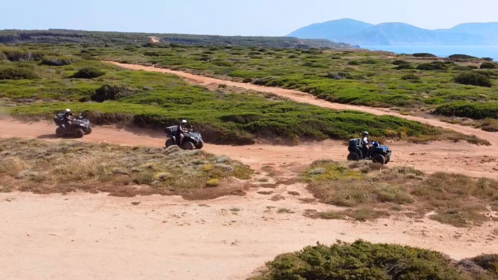 Three quad bikes navigating through the scenic trails of Alghero, offering an exhilarating off-road experience.