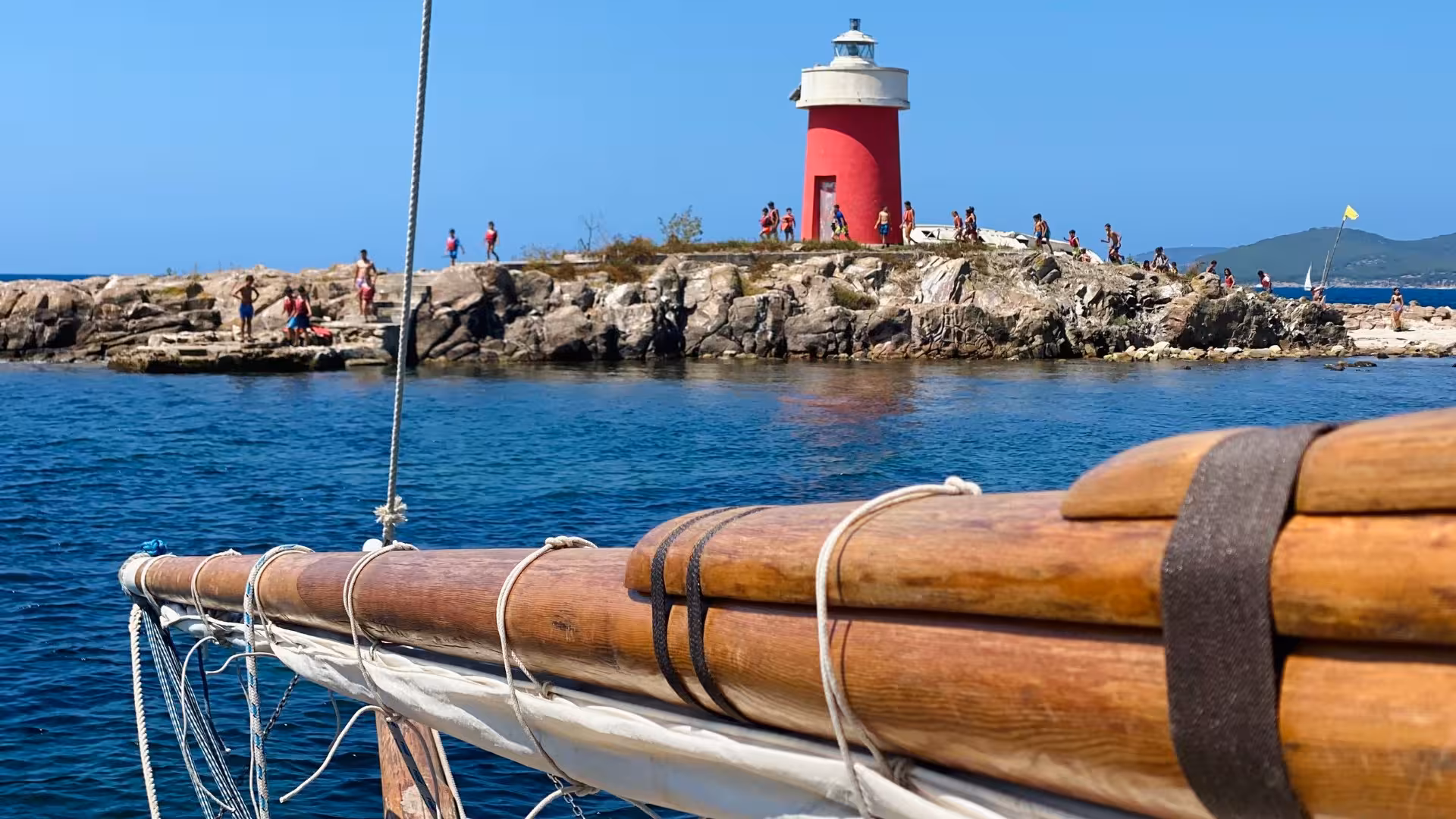 Sail past Alghero's iconic red lighthouse and rocky shores on a scenic 4-hour boat tour.