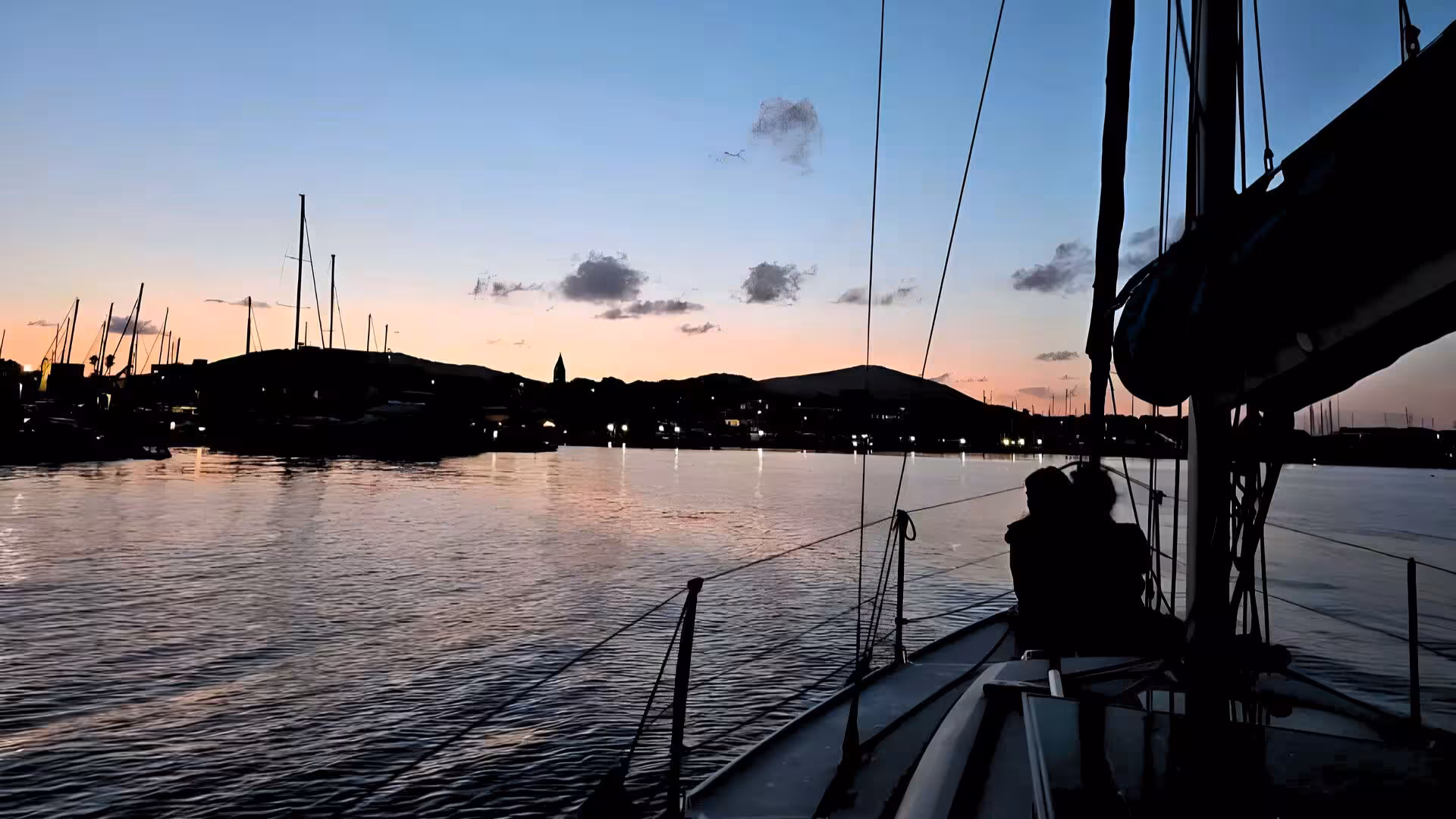 Experience a breathtaking Alghero sunset sailing tour from Fertilia with serene views and calm waters.