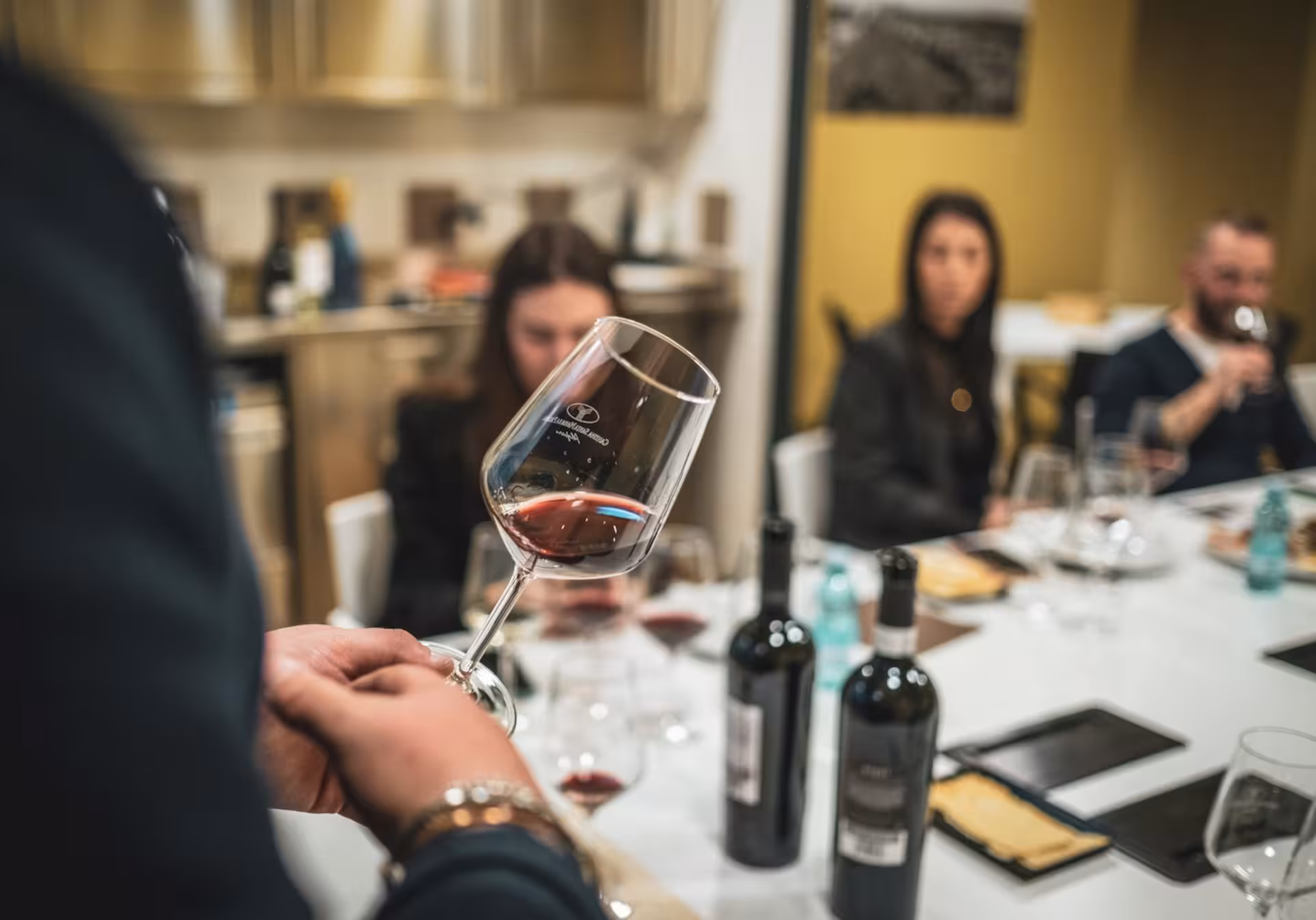 Wine tasting experience in Alghero with glasses of red wine, enhancing the cultural tour with local flavors.