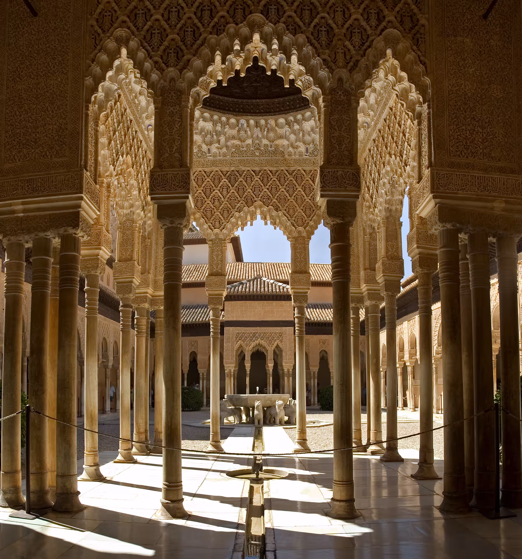 Majestic arches and columns in the Court of the Lions at the Alhambra, highlighting Moorish architecture.
