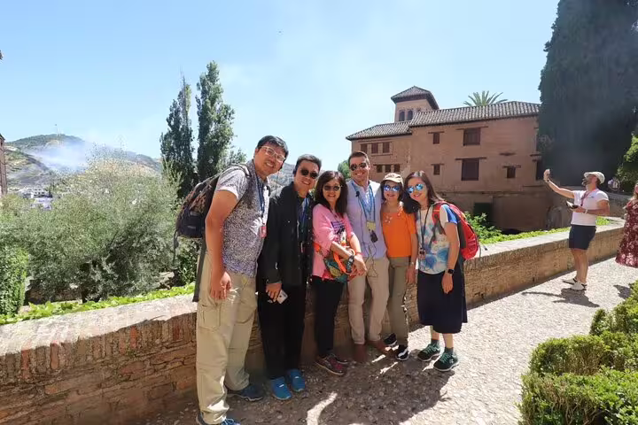 A group of cruise passengers enjoys a sunny tour at the Alhambra in Granada, with scenic views from Malaga Port.