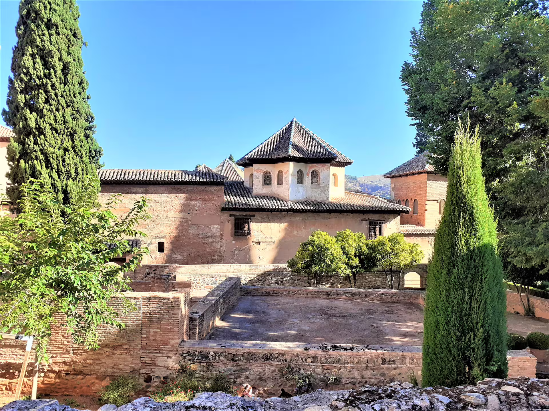 Scenic Alhambra group walking tour view of Nasrid-era buildings and gardens inside the Granada fortress