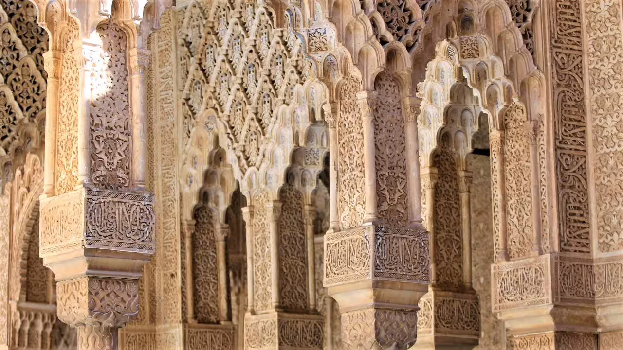 Close-up of Alhambra Nasrid Palace arches and intricate stucco carvings, Granada group tour from Costa del Sol