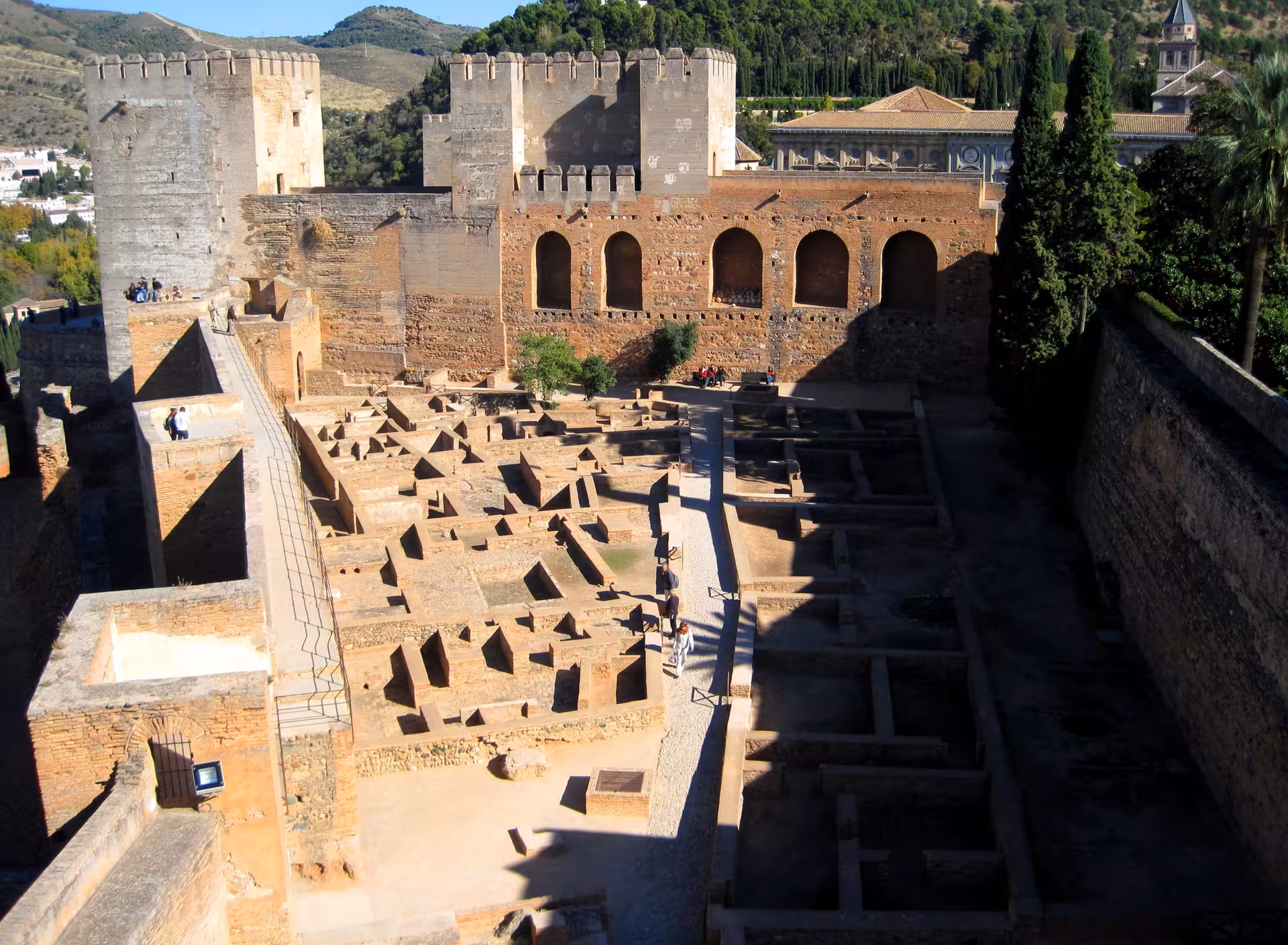 Aerial view of Alhambra's ancient fortress walls and archaeological site in Granada, Spain.