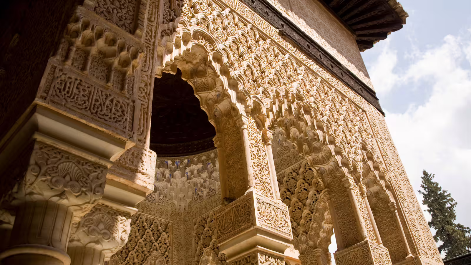 Close-up of intricate Nasrid stucco arch on an Alhambra private walking tour in Granada, Spain, UNESCO site