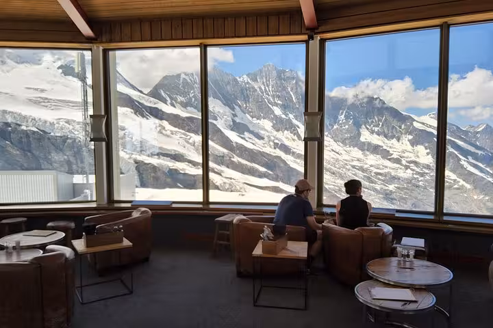 Allalin revolving restaurant lounge with panoramic Swiss Alps views on a Zurich day trip to Saas-Fee