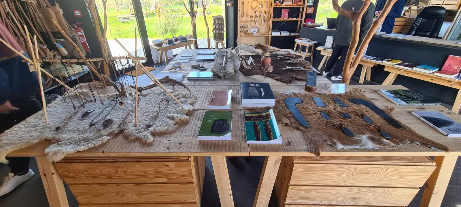 Exhibit of archaeological artifacts and books at the Almendres Interpretive Center in Évora.