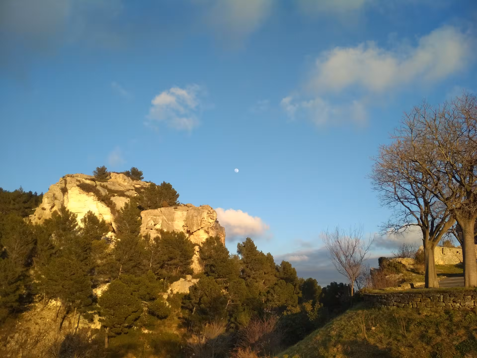 Golden-hour view of Alpilles limestone cliffs near Les Baux-de-Provence, scenic stop on Arles Provence tour