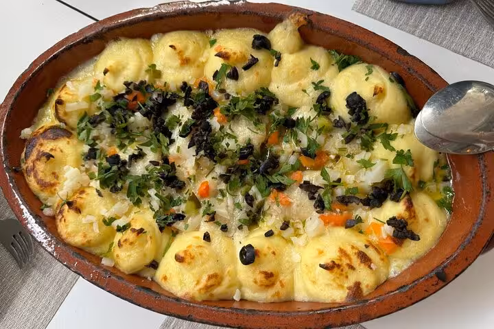 Traditional Portuguese bacalhau dish served in a clay pot during Alto Douro Wine Region guided tour experience