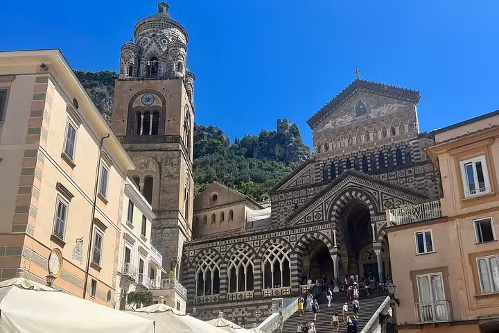 Historic cathedral facade in Amalfi, showcasing stunning architecture on a full-day tour from Sorrento by minivan.